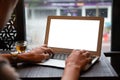 Young entrepreneur SME use notebook showing blank screen with clipping path display in cafe concept.ÃÂ Hand of business man hold
